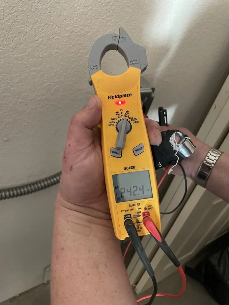 Voltage testing with clamp meter during Ceiling Fan Installation in Asheville